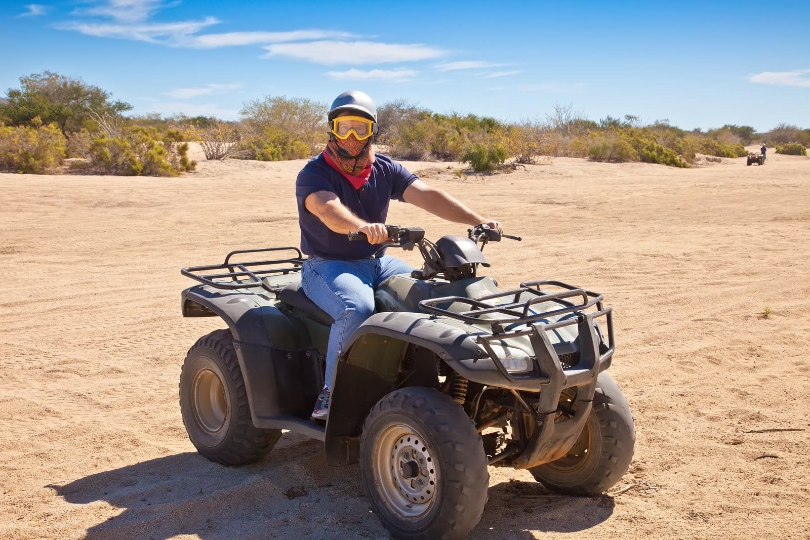 Rider on a four-wheel ATV on a desert trail outside Cabo