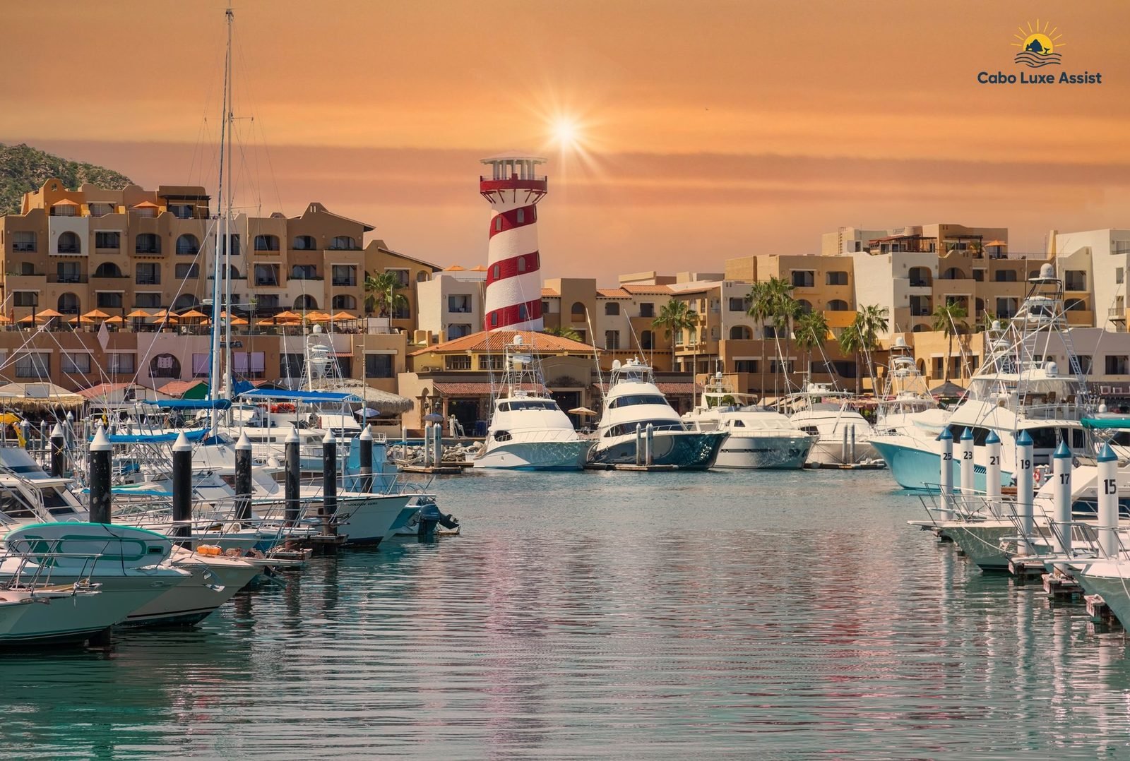 Marina Cabo San Lucas at golden hour, the El Faro lighthouse over the slips and boats tied up